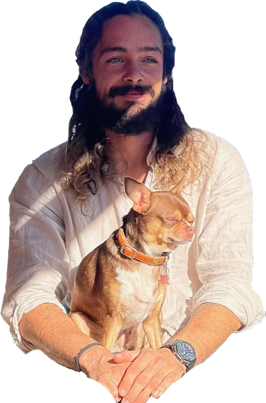 Hugo, smiling, holding Pepita the chihuahua